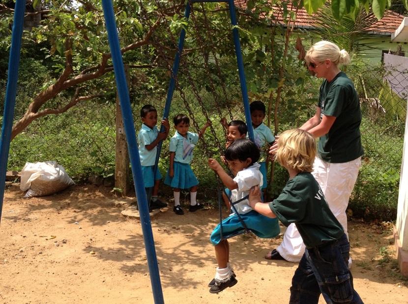 Pushing the children on the swings Pushing the children on the swings
