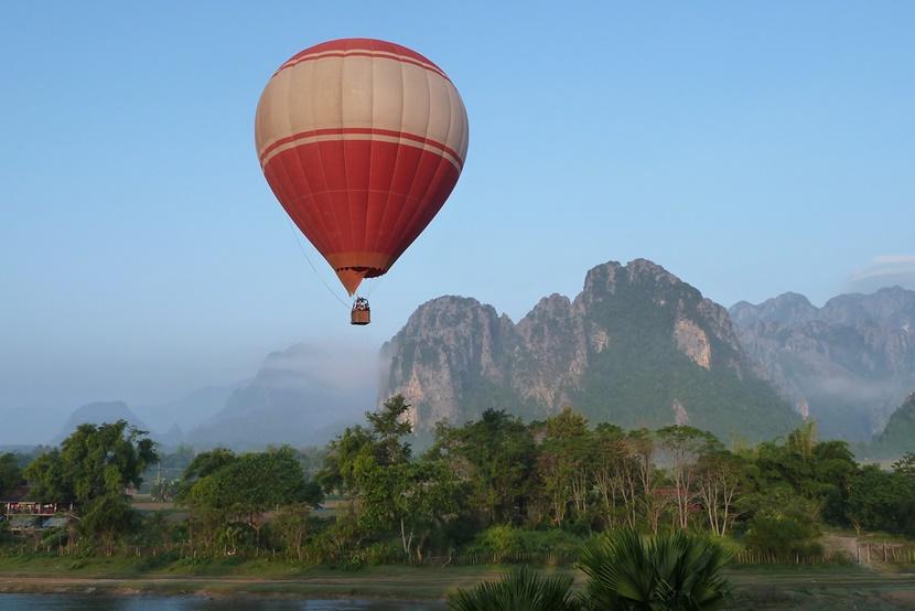 A hot air balloon sails across the sky in Vang Vieng Hot air balloon floating over Vang Vieng