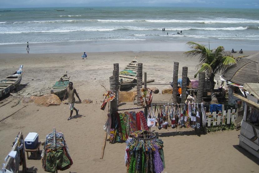 Ghanaian beach with goods for sale Boats and market on a beach