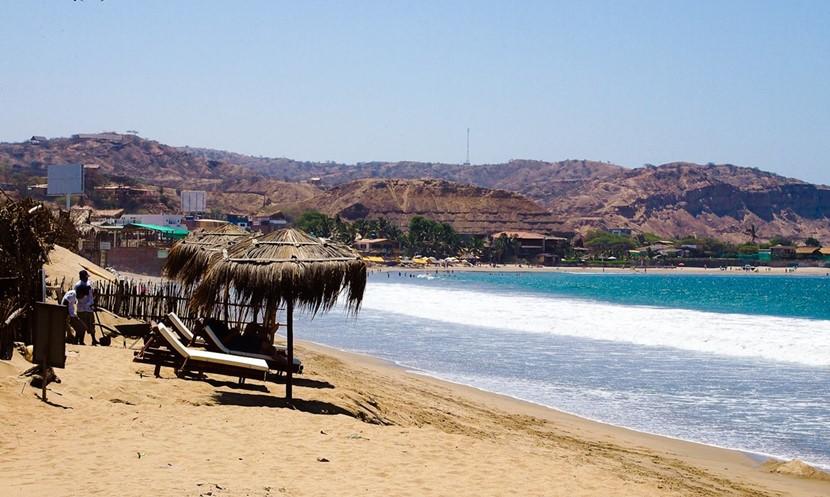 Grass umbrellas on the beach Mancora beach in Peru