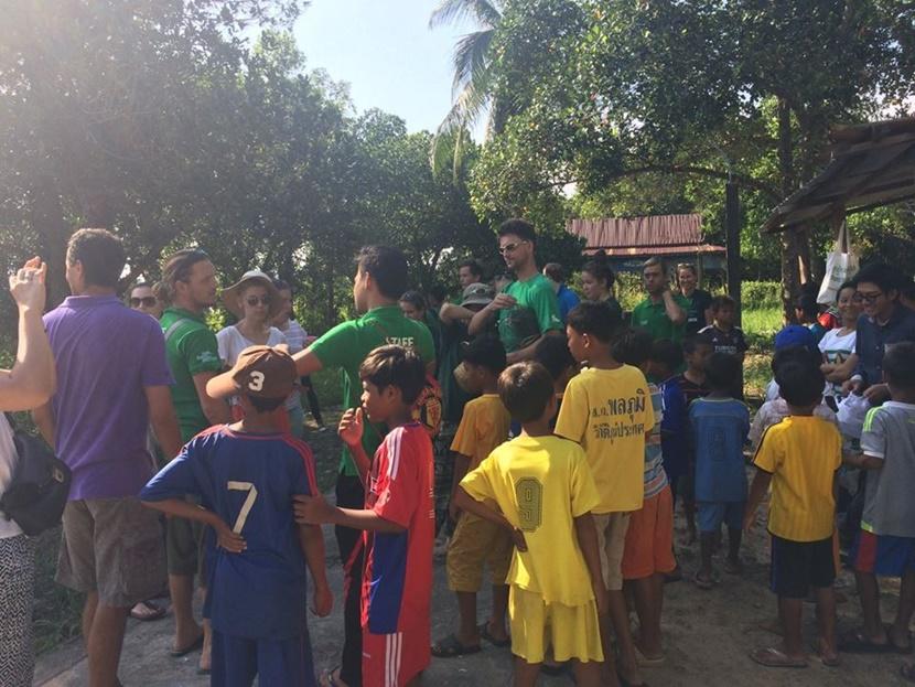 Local children before a village clean-up Cleaning up the community with the local children