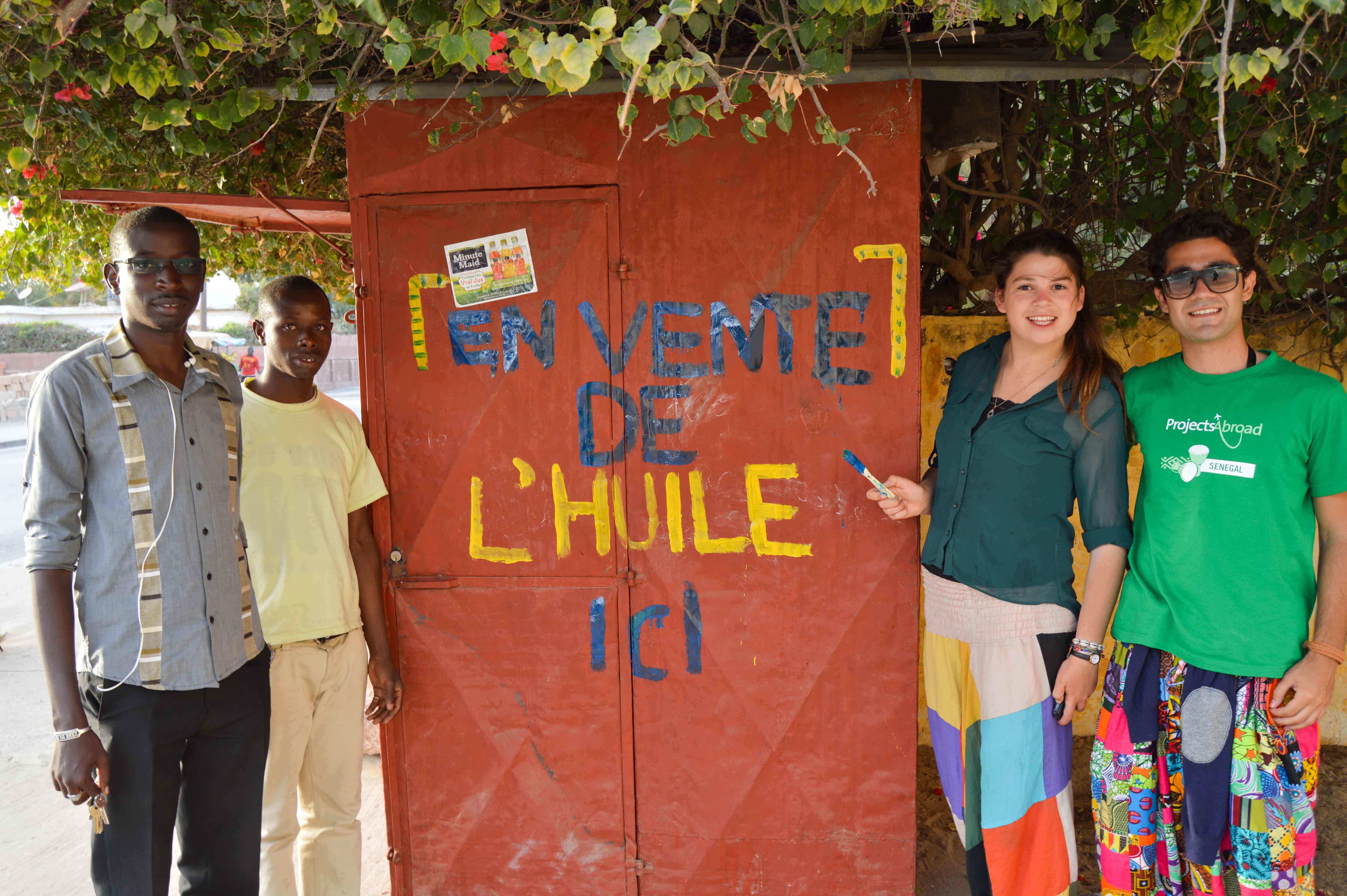 Volunteers with micro-finance project coordinator and project beneficiary Projects Abroad volunteers with micro-finance project coordinator and project beneficiary