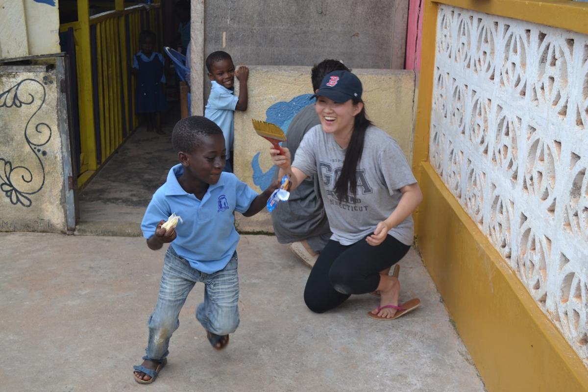 A child in Ghana and a High School Special volunteer have fun at a placement. A teenager under the age of 18 spends time with children in Ghana during her first volunteer trip.