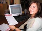 Projects Abroad staff member, Ximena, with a copy of the Cocha-Banner