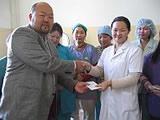 Mongolia Country Director Oko making the donation