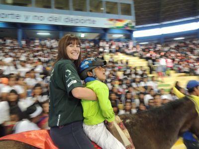 Volunteer Trish, from the UK, and little David, rode in the ceremony together Equine therapy volunteers participated in the Bolivian Olympics
