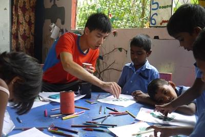 A volunteer at a Care project in Sri Lanka runs activities for a group of children Projects Abroad Care volunteer, Herman Chi Hong Chan, does arts and crafts with children at his placement at Dutch Anne Preschool in Panadura.
