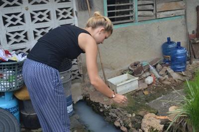Volunteers apply larvicide around the homes of host families in the Philippines Projects Abroad volunteers demonstrate to local host families how to use larvicides around their home to prevent the spread of dengue.