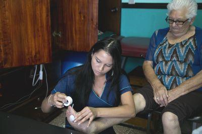 A physiotherapy volunteer treats a senior resident A senior receives electrode treatment from Projects Abroad volunteer for a foot problem at Asociacion Centro de Atención al Anciano Francisca Valerio Badilla