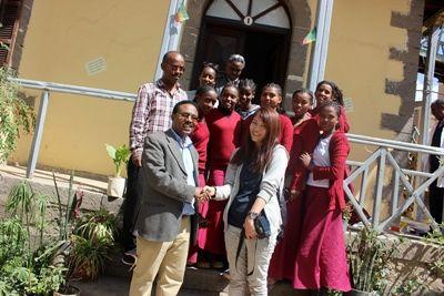 The Director of Berhane Zare School stands with newly donated books for his students Projects Abroad staff and volunteers present a donation of academic and fictional books to the Director of Berhane Zare School in Addis Ababa, Ethiopia