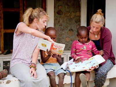 Volunteers read a story to children at their Teaching project in Tanzania Projects Abroad Volunteers on a Teaching project in Tanzania read a story to young children at their placement