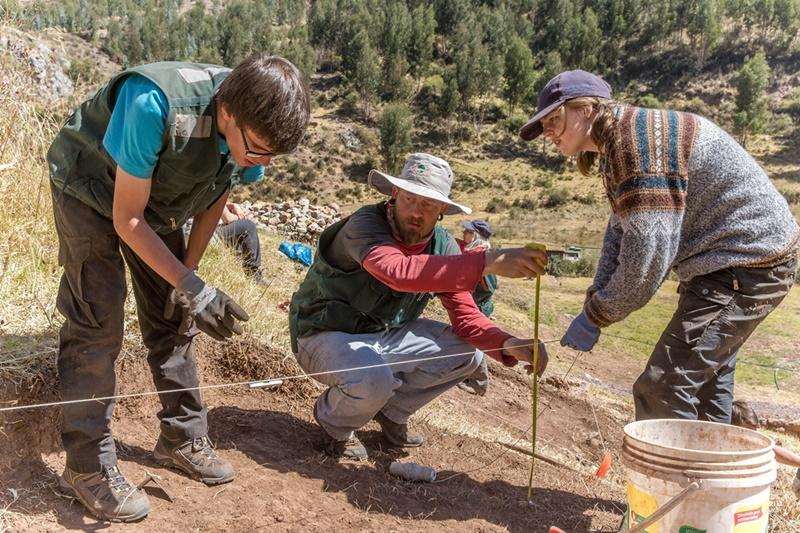 British volunteer, Ben Carrick, and German volunteer, Selina Zunino, help a local staff member to check the depth of the excavation site in Sacsayhuaman Volunteers on the archaeology project log the dimensions of the excavation site in Sacsayhuaman