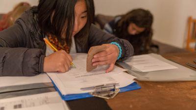 South Korean high school special archaeology volunteer, Soyoung Joo, records the description of a piece of ceramic uncovered during excavations High School Special volunteer records data from ceramic
