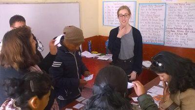 Female volunteer teaching the local teachers how to pronounce certain English words Teaching volunteer using her vocals to enunciate English words
