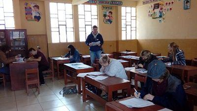 Teaching volunteers marking the work and planning new lessons for the local teachers during their training sessions Volunteers working during the annual Teacher Training project in Peru