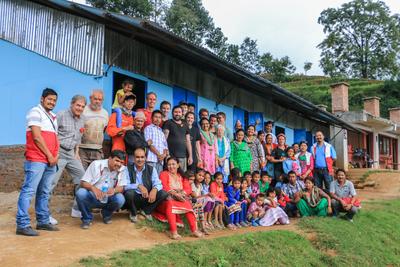 A group photo outside the new classrooms Building volunteers, Projects broad staff, staff and students from Shree Phulchoki Primary School, and members of the Nepal Youth foundation outside the newly built classrooms in Nepal