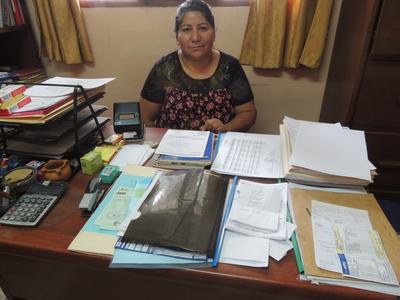 Director of the Sayariy Warmi Centre sitting at her desk Director Libia Chávez of a centre for abuse and anti-human trafficking in Bolivia