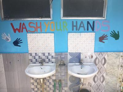 A mural painted by High School Special volunteers A mural to remind children at a Care placement about hygiene practices