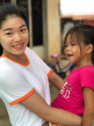 High School Special Care & Community volunteer with a young girl from SCC2 Female volunteer playing with a child at her Care placement
