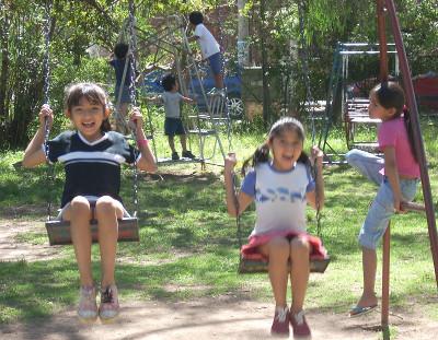Children on the swings at the orphanage Children on the swings at the orphanage