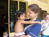 Holding one of the children Holding one of the children