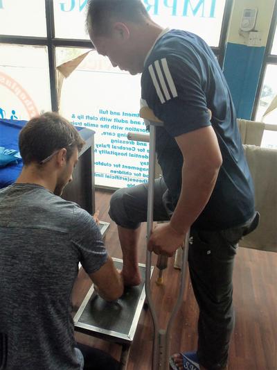A volunteer assists at his Physiotherapy placement A volunteer assists at his Physiotherapy placement