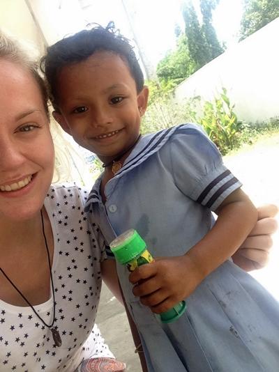 Jessica takes a photo with a local child at her project Jessica takes a photo with a local child at her project