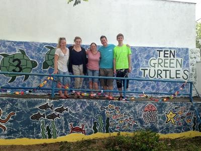 Volunteers with the mural painted at their placement Volunteers with the mural painted at their placement