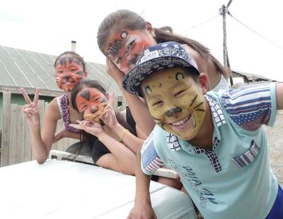 Mongolian children enjoy a face-painting activity at a day care centre Mongolian children enjoy a face-painting activity at a day care centre