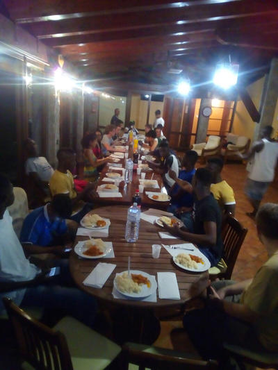 The refugees enjoing a meal together at the shelter The refugees enjoing a meal together at the shelter