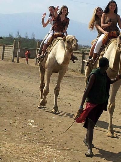 Volunteers riding camels in Tanzania