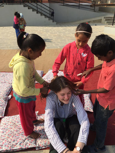 Kate getting her hair done by local children Kate getting her hair done by local children