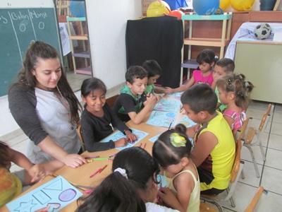 Katia helps children with an educational activity at her care placement Katia Gibson
