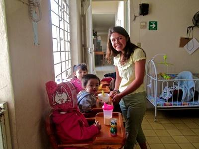 Katia helps feed the babies at the nursery Katia Gibson