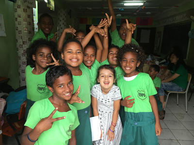 Local school children spending time with a young volunteer Local school children spending time with a young volunteer