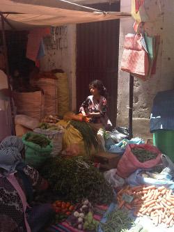 Quechuan girl with her produce at La Cancha market, Cochabamba