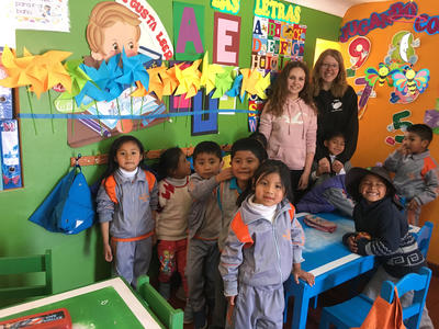 Volunteers in a classroom with the children Volunteers in a classroom with the children