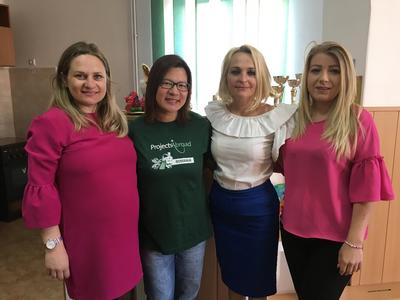 A volunteer with teachers from a local school in Romania A volunteer with teachers from a local school in Romania