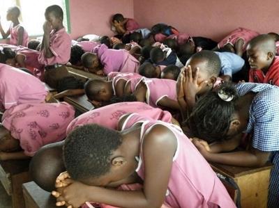Class of students praying Class of students praying