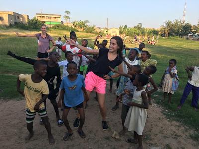 Volunteers and children dancing together Volunteers and children dancing together