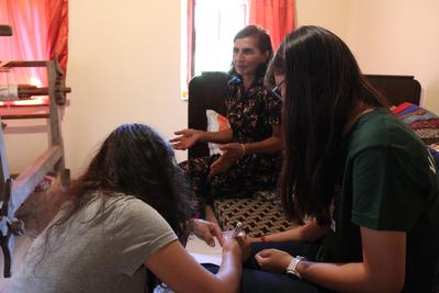 Journalism volunteers interviewing a local woman Journalism volunteers interviewing a local woman