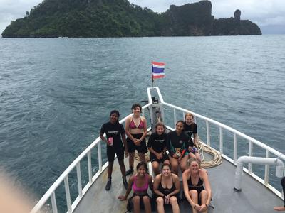 Conservation volunteers spending time on a boat together Conservation volunteers spending time on a boat together