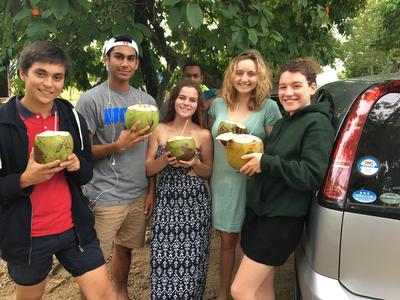Volunteers drinking from coconuts during their free time Volunteers drinking from coconuts during their free time